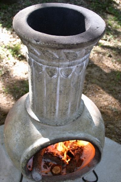 Chiminea with fire on concrete slab