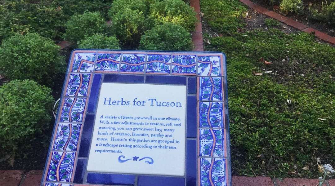 A tile sign describes herbs that can be grown in Tucson at the Tucson Botanical Garden